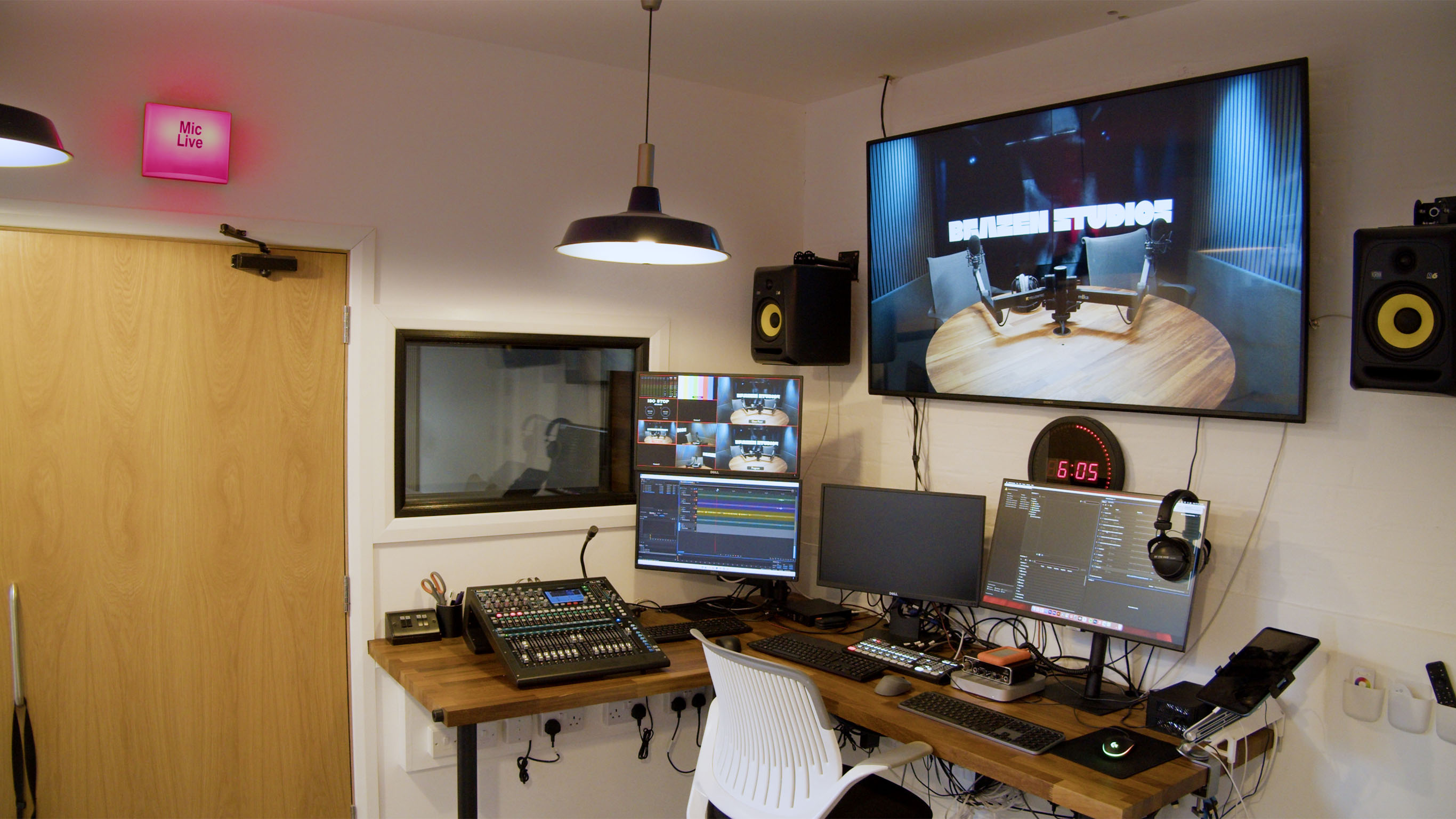 State-of-the-art control room at Brazen content creation studio in London with multi-screen live editing suite, camera feed monitors and professional sound mixing console.